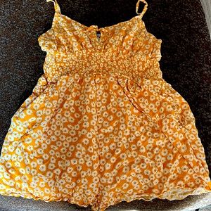 Sunflower yellow romper adjustable straps worn twice. Short.